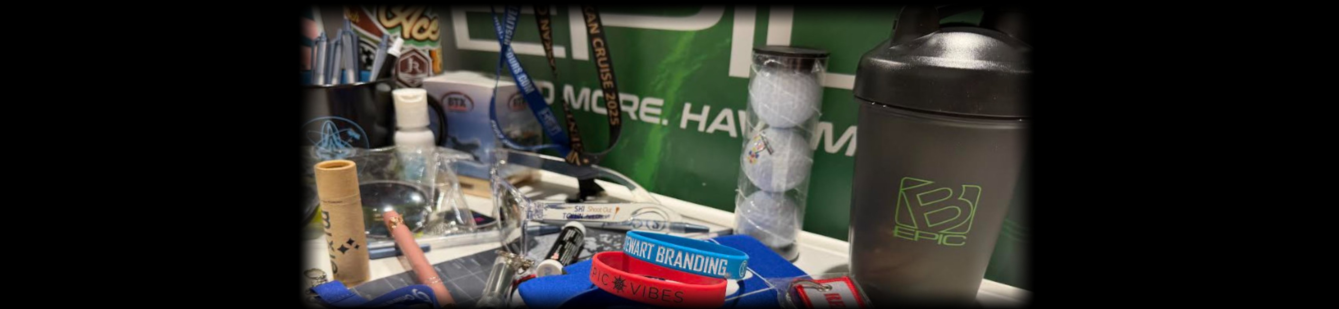 Stewart Branding promotional products display — lanyards, drinkware, golf balls, wristbands, and branded accessories
